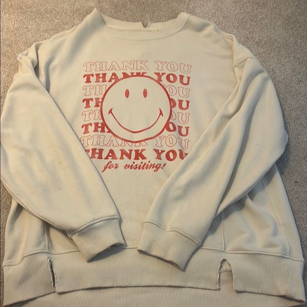 White Sweatshirt with Red Smiley Design